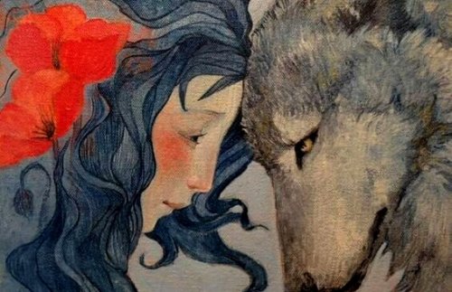 Vrouw en wolf houden hun hoofden tegen elkaar aan, het is een wilde vrouw en haar wolvenziel.
