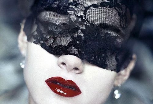 Vrouw met een kanten doekje om haar ogen gebonden en rode lippenstift op haar lippen