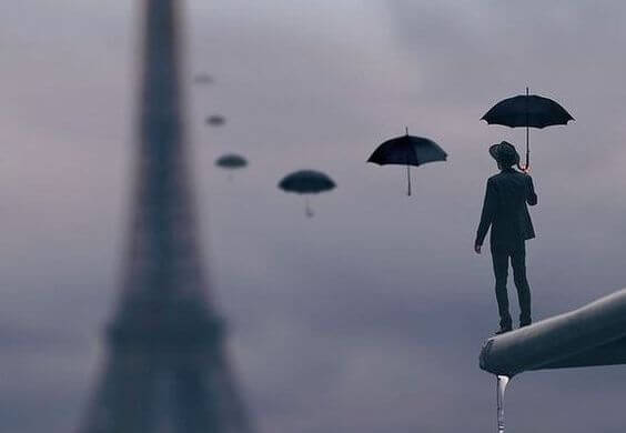 Man die kijkt naar een rij paraplu's die naar de Eiffeltoren reiken 