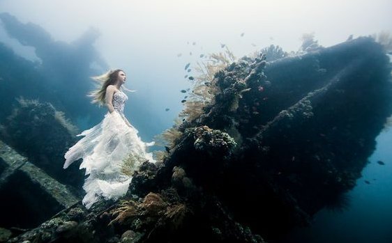 Vrouw die onder water staat op een gezonken schip