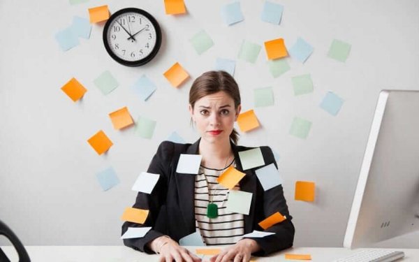 Meisje dat helemaal overspoeld wordt met taken, waardoor jezelf loskoppelen van je werk nog moeilijker wordt