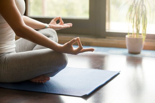 Vrouw die mediteert in haar woonkamer, maar wat zegt de wetenschap over meditatie