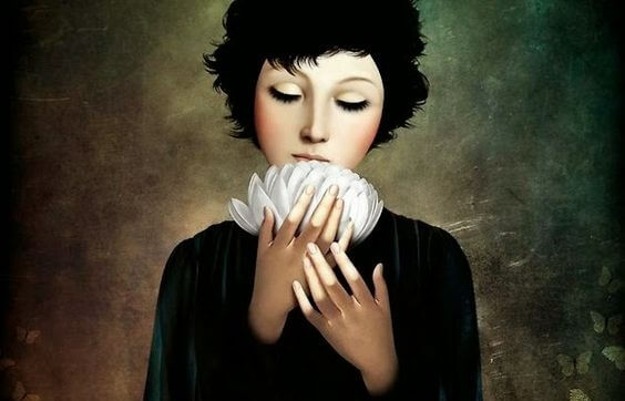 Vrouw die een lotus in haar handen houdt en het moeilijk vindt om oude patronen te doorbreken