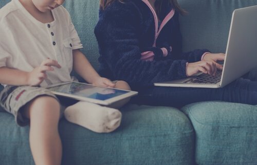 Kinderen zitten op tablet en laptop