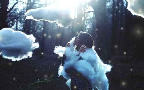 Meisje in een bos met wolken om zich heen