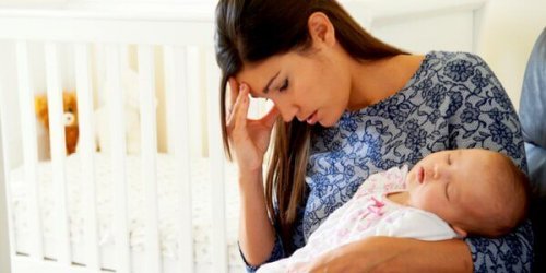 Uitgeputte moeder met baby in haar armen