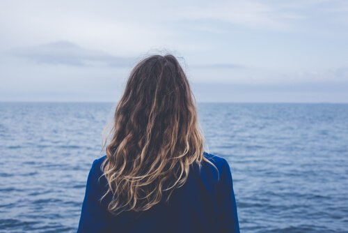 Vrouw kijkt uit over zee
