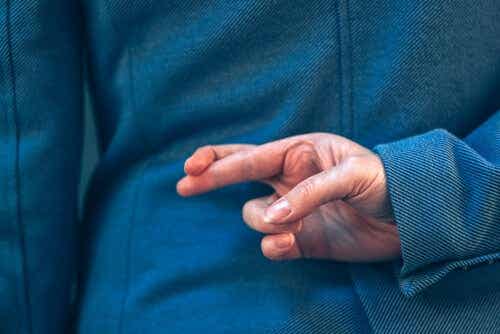 Een man houdt zijn vingers gekruist achter zijn rug